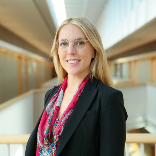 Image of Dr. Alexandria Nylen, wearing black blazer, pink blouse, and glasses.