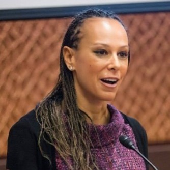 Woman speaking passionately at lectern