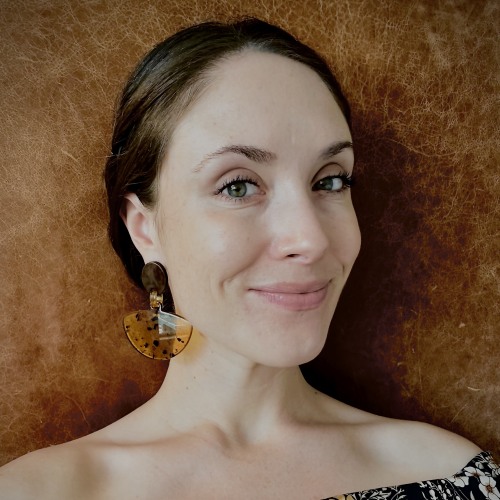 Woman with brown hair smiling at camera.
