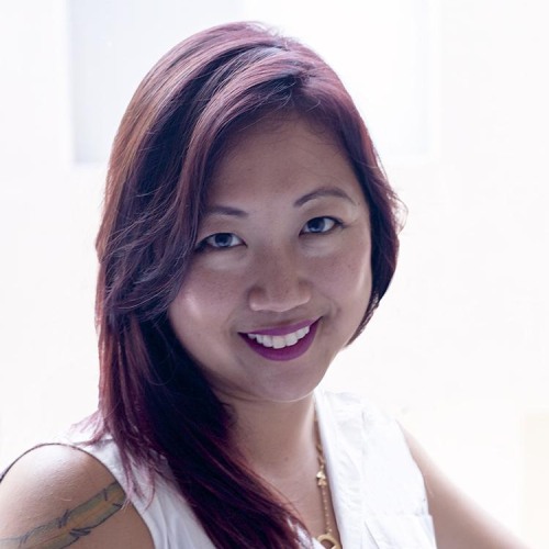 Woman with long red hair smiling at camera.