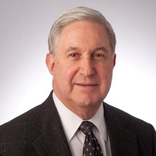 Man in suit looking straight ahead with a slight smile.