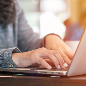 Woman typing on laptop. 